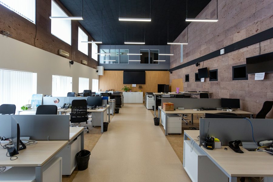 Office with desks and bright ceiling lighting