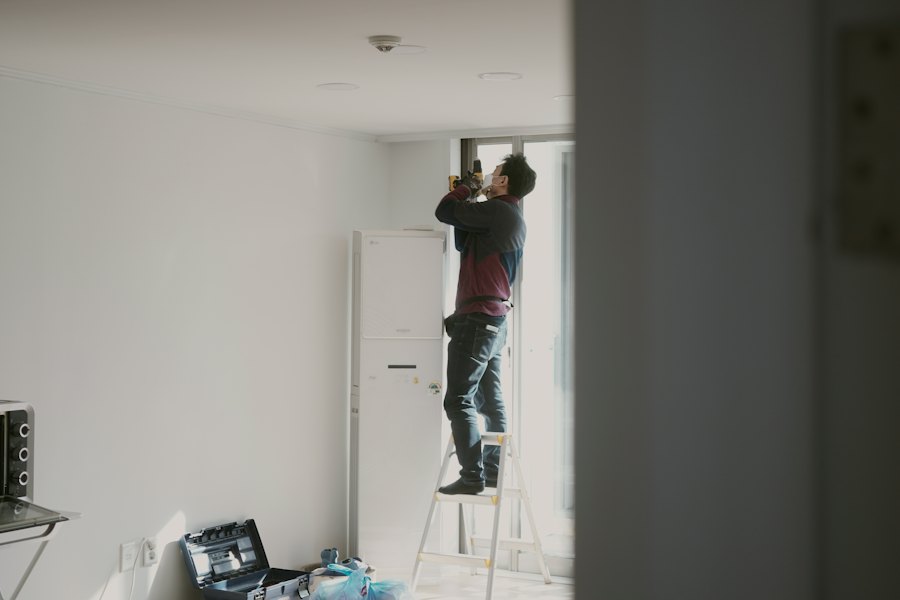 Electrician working on the ceiling from a stepladder