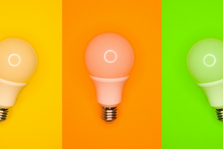 Three LED bulbs against a coloured background